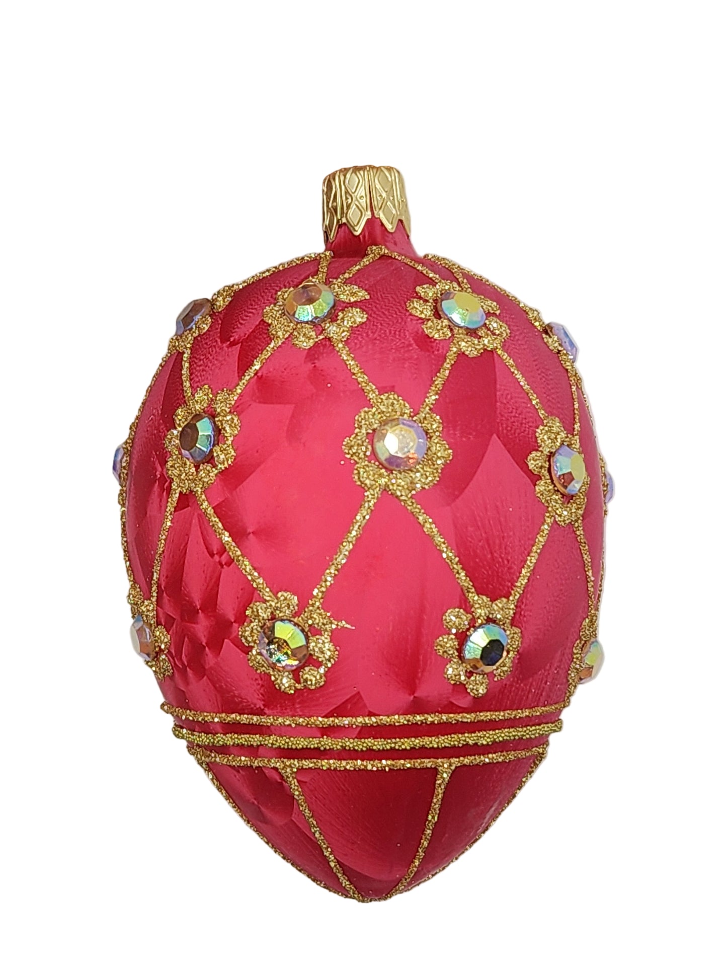 Decorative red egg with gold and gemstone details against a light background