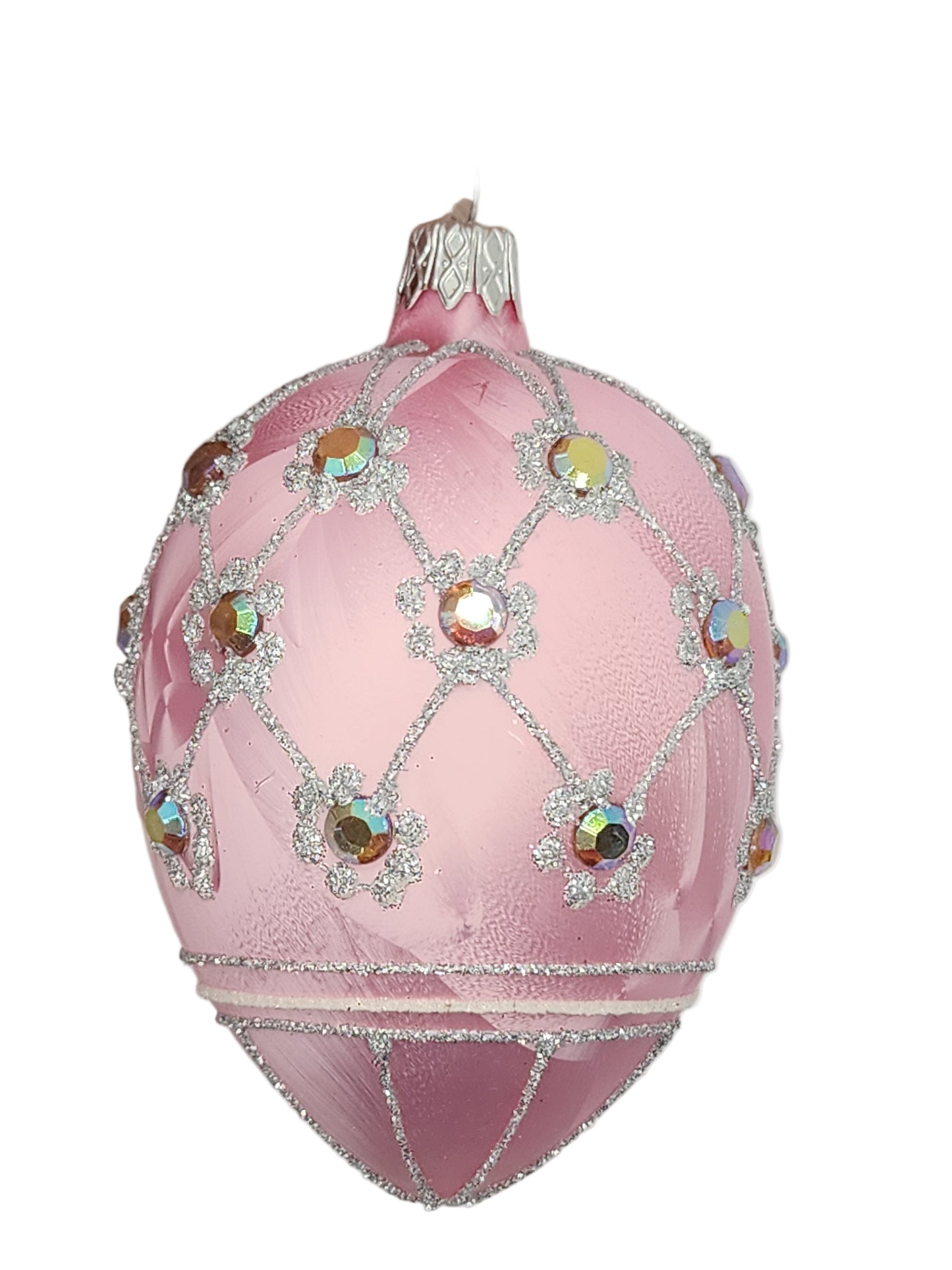 Decorative pink egg with gemstones against a white background