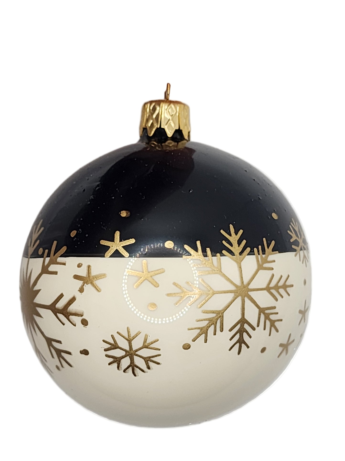 Black and white ornament with gold snowflake patterns against a white background