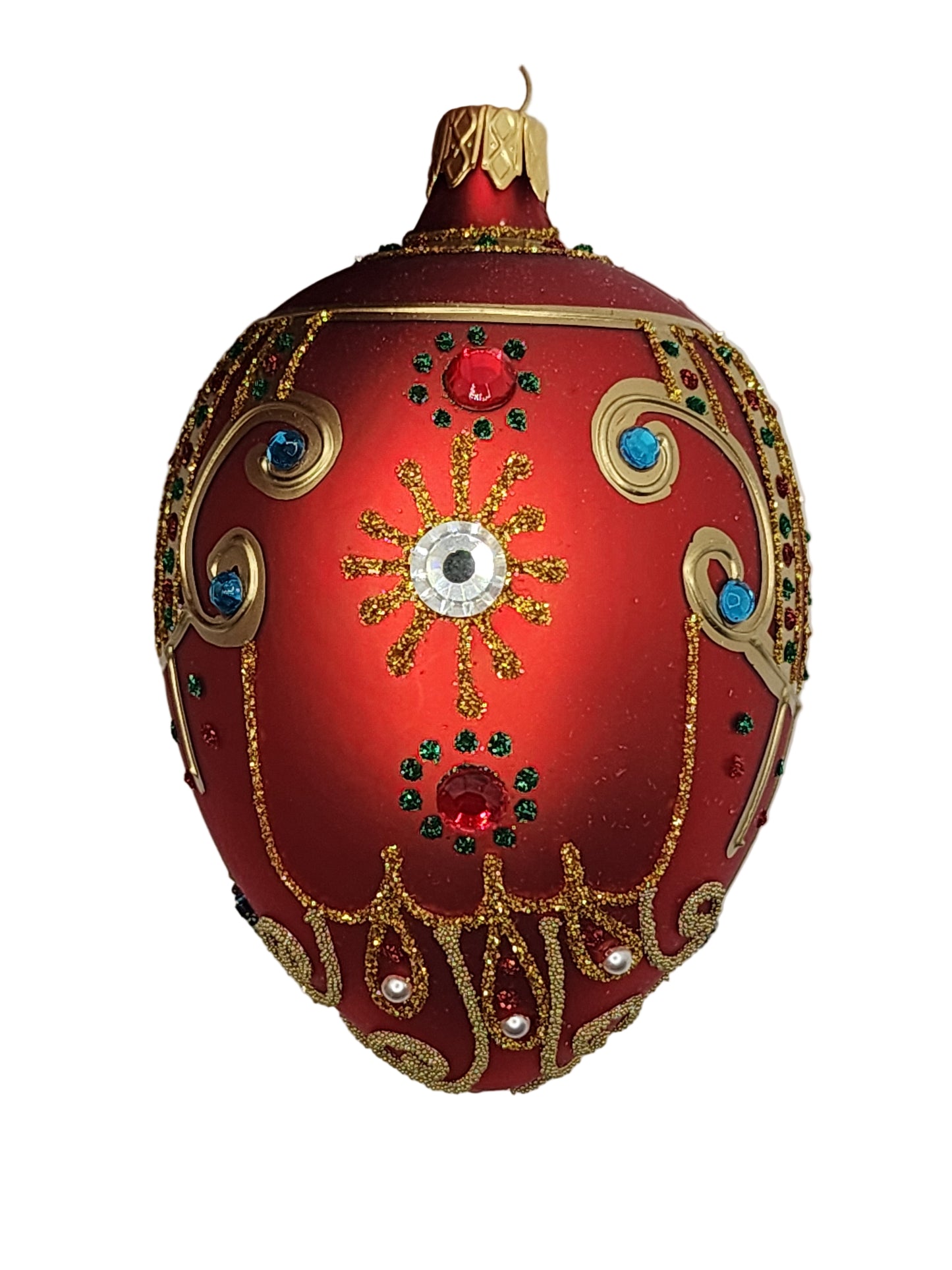 Decorative red egg with gold and gemstone details on a white background