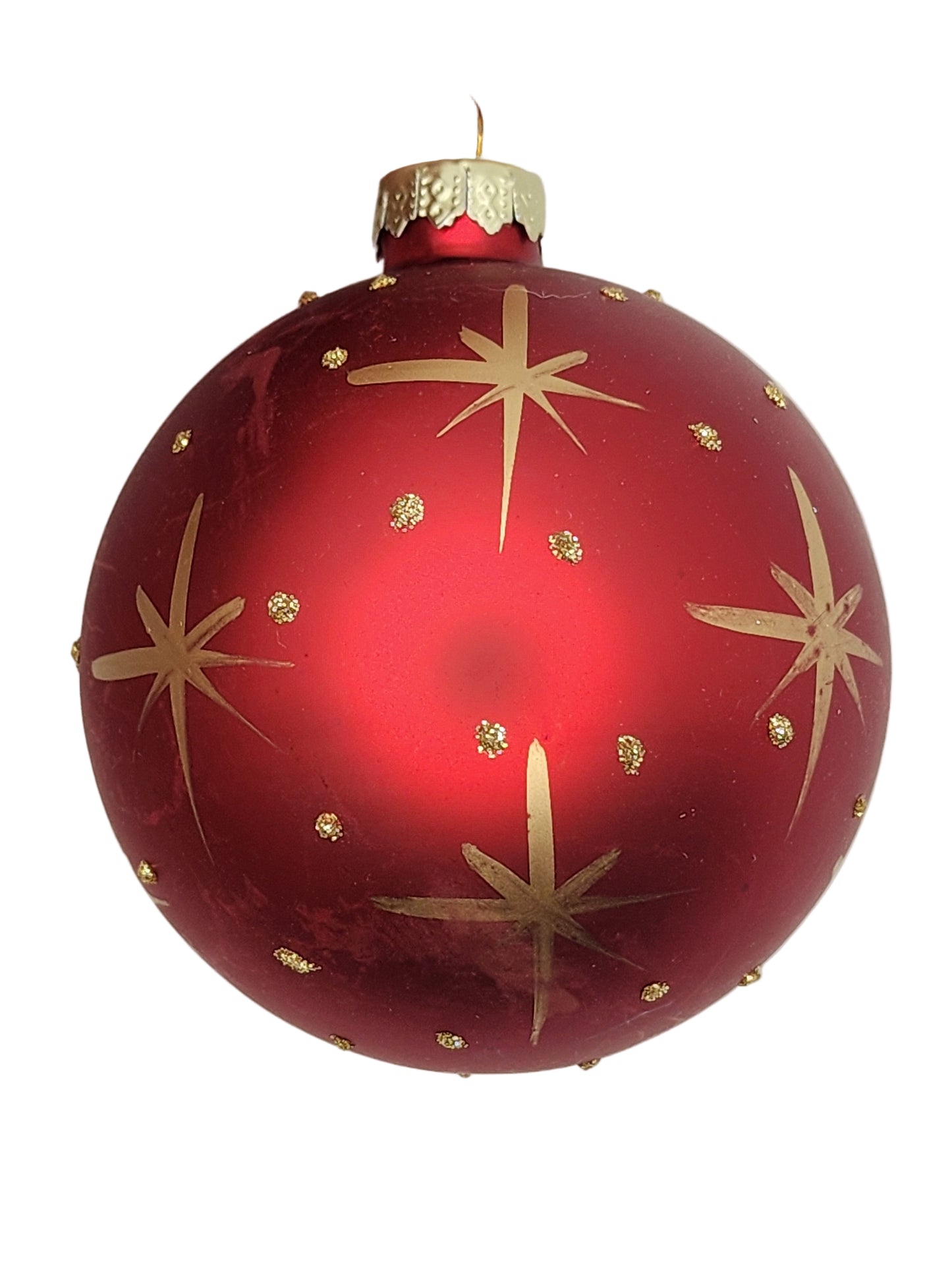 Red Christmas ornament with gold star patterns against a white background
