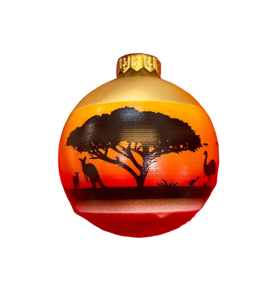Decorative ornament with sunset design and tree and Australian animal silhouette on a white background