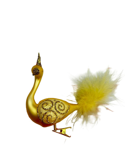 Gold bird feather decoration on a white background