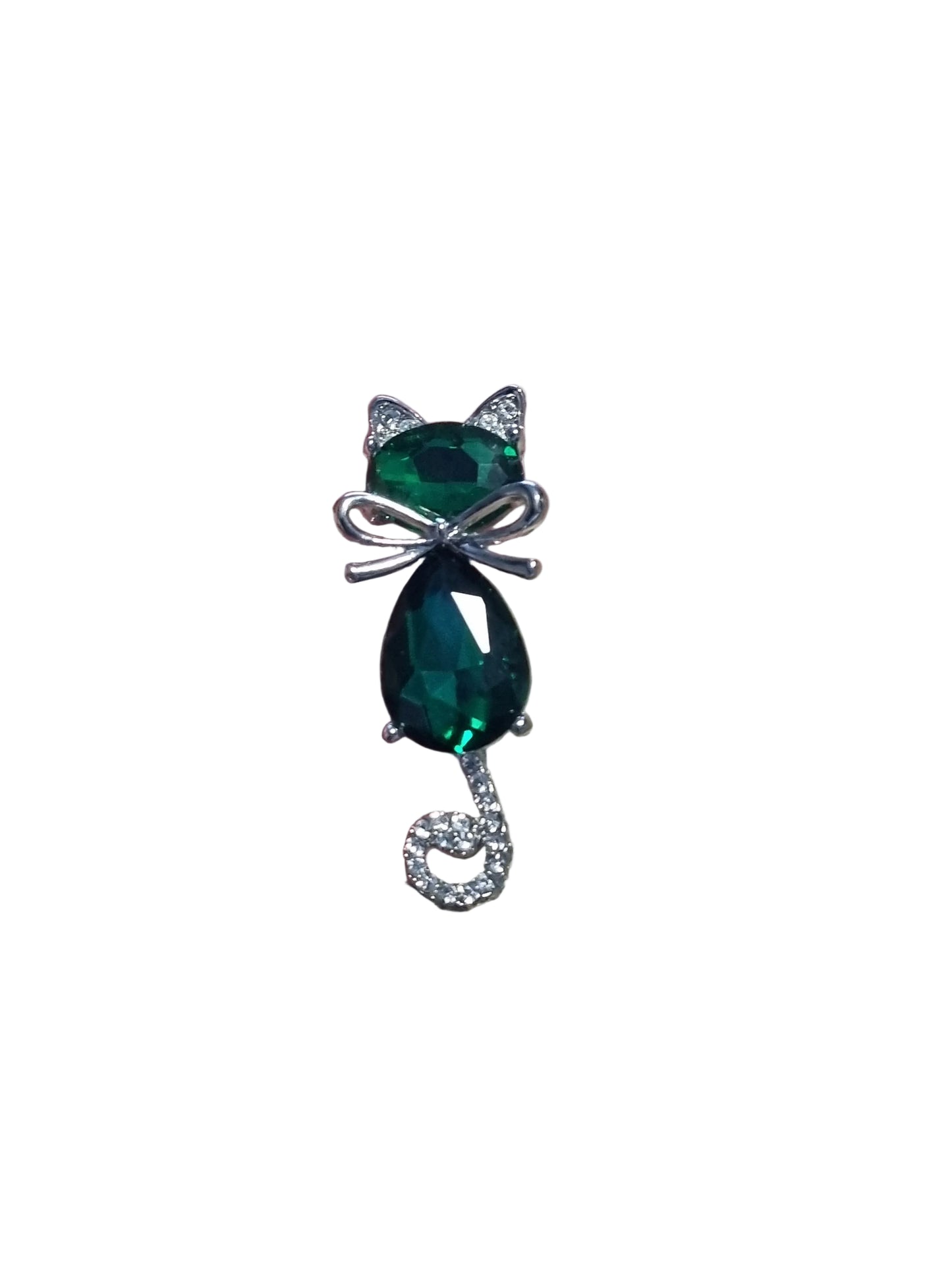 A cat shaped brooch with green gemstones and silver accents 