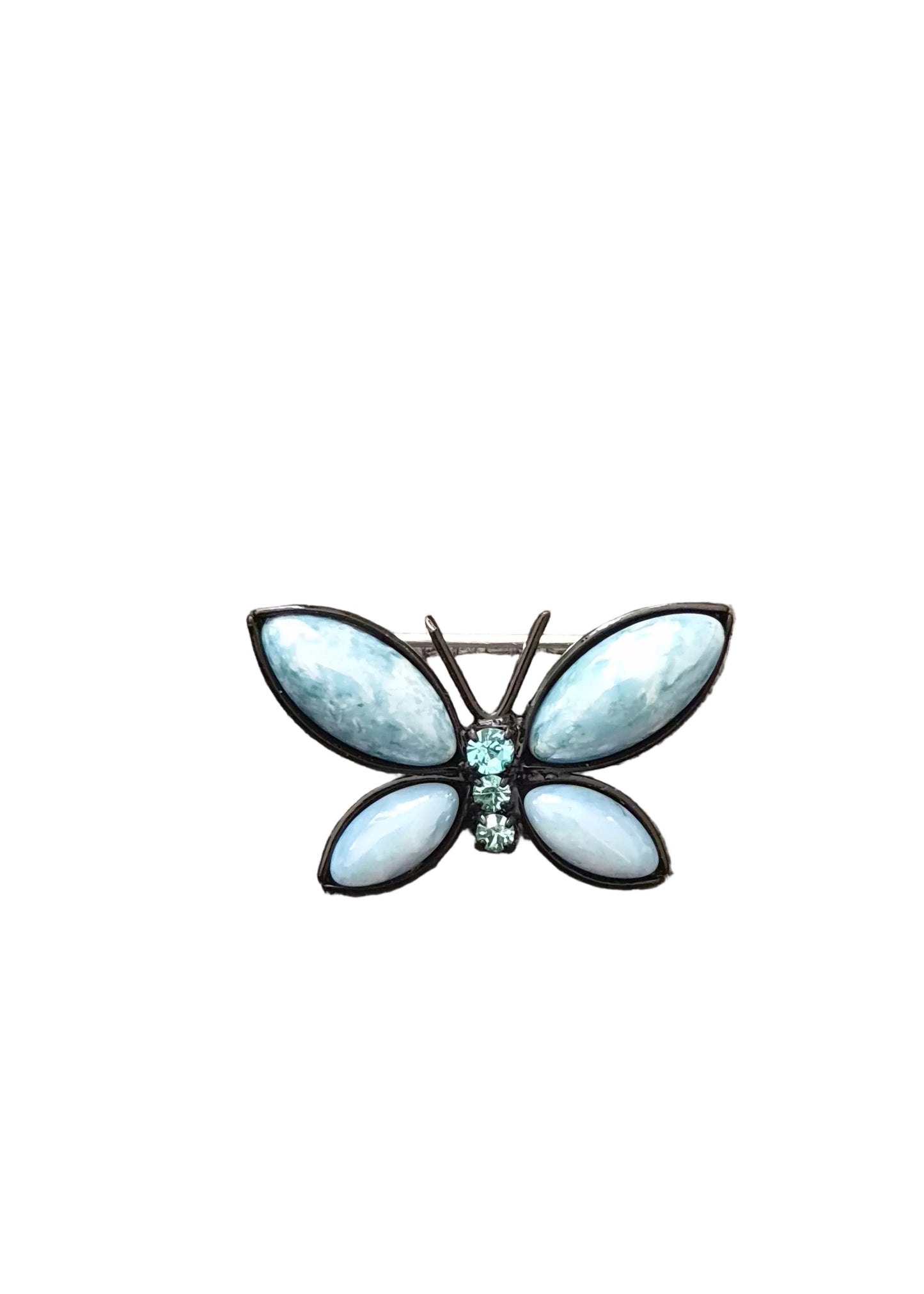 A butterfly-shaped brooch with light blue marbled wings and a small central cluster of clear stones, set in dark metal.