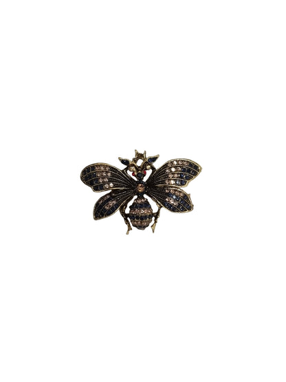 Decorative brooch on a white fabric background