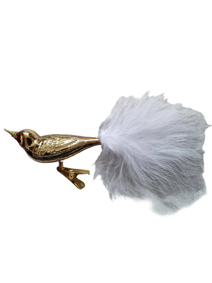Gold bird-shaped object with a white feather 