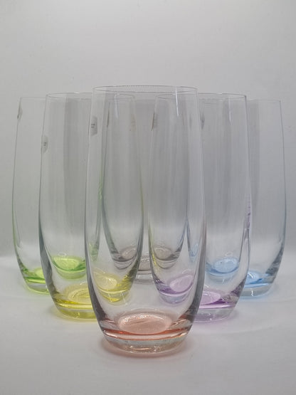 Set of colourful glass tumblers on a white background