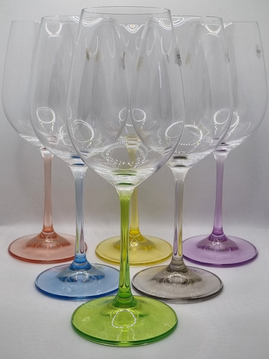 Set of colourful white wine glasses on a white background