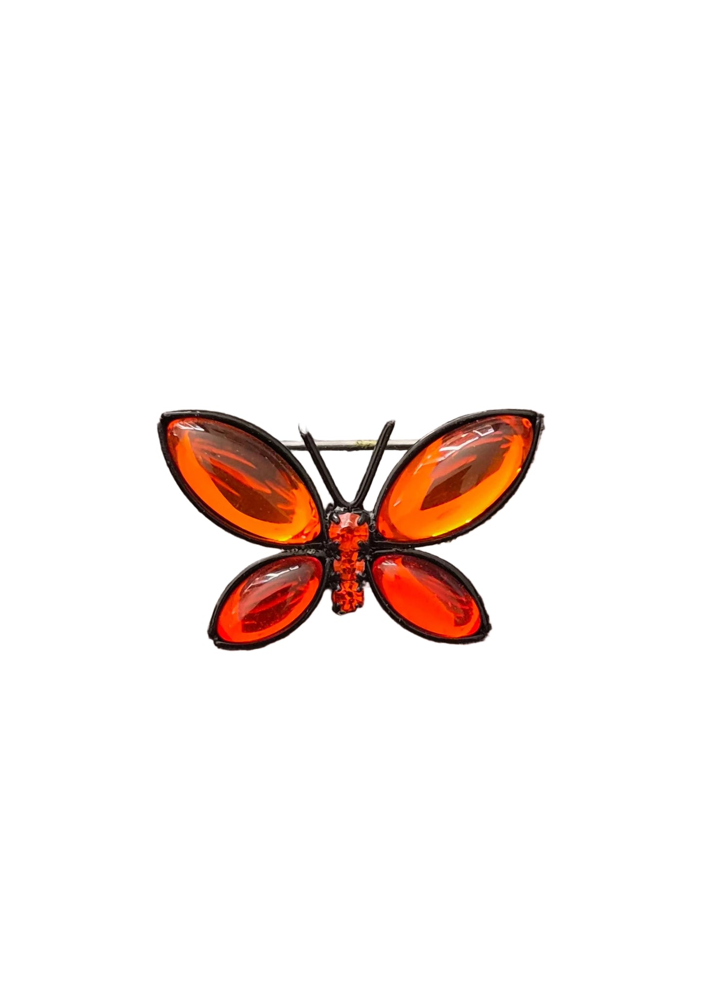A butterfly-shaped brooch with translucent orange wings and a red body.