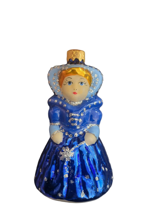 Decorative figurine of a queen in a blue dress with a gold top