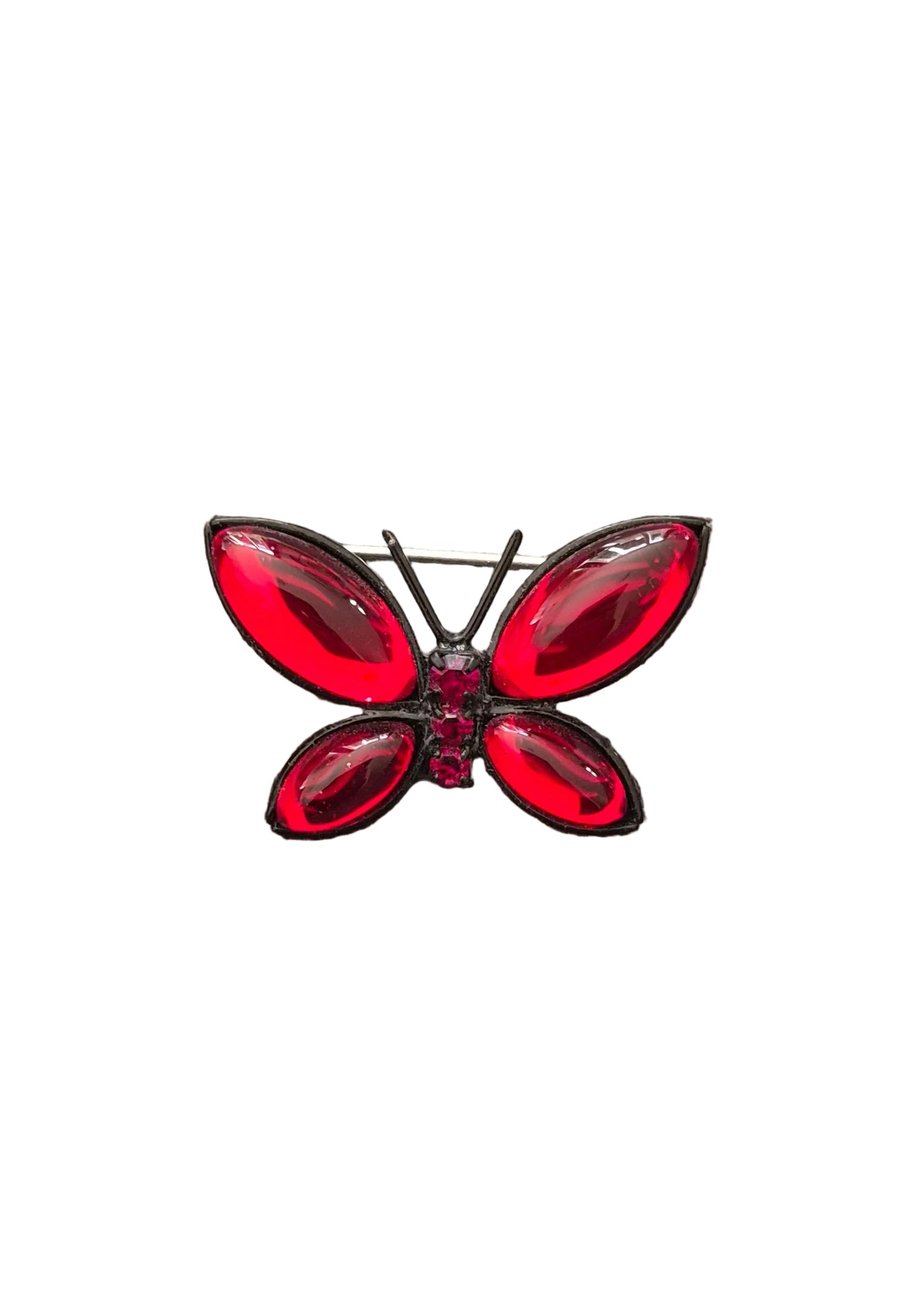 A butterfly-shaped brooch with glossy red rhinestone wings and a black metal body.