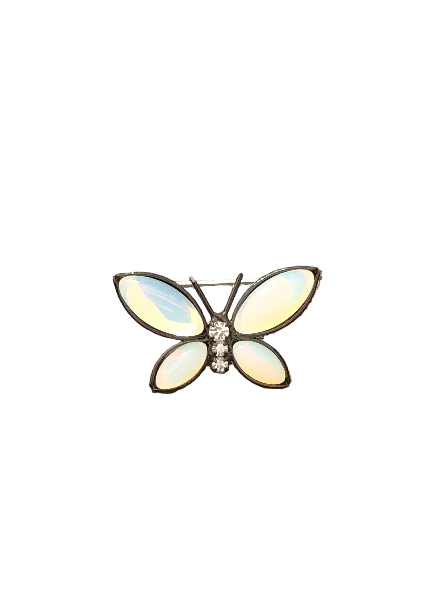 A butterfly-shaped brooch with iridescent white opal-like wings and a small clear crystal center, set in silver-toned metal